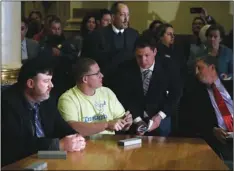  ?? AP PHOTO/BRENNAN LINSLEY ?? In this 2016 file photo, Colorado elector Micheal Baca (second from left) talks with legal counsel after he was removed from the panel for voting for a different candidate than the one who won the popular vote, during the Electoral College vote at the Capitol in Denver.