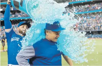  ?? FRANK GUNN, THE CANADIAN PRESS ?? The Blue Jays' Kevin Pillar pours a barrel of sports drink over departing manager John Gibbons after Wednesday’s win over the Houston Astros at Rogers Centre.