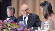  ?? POOL PHOTO BY GETTY IMAGES ?? Dinner host Larry Wilmore chats with first lady Michelle Obama. Wilmore ended the lightheart­ed evening on a serious note, thanking the president for the barriers he has broken.