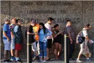  ?? RICHARD VOGEL AP PHOTO BY ?? People line up at the California Department of Motor Vehicles prior to opening in the Van Nuys section of Los Angeles on Tuesday, Aug. 7.