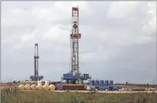  ?? LUIS SÁNCHEZ SATURNO/New Mexican file photo ?? Two drilling rigs sit in New Mexico’s Eddy County in 2020. State lawmakers expect a big financial hit to the general fund down the road after President Joe Biden announced a moratorium on oil and gas leases on federal lands.