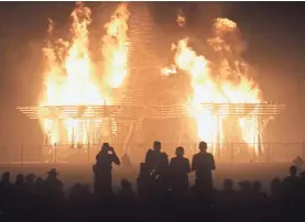  ?? USA TODAY ?? Burning Man attendees watch the Temple burn last year.