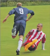  ??  ?? No way through for Saints striker Dean Smith as he is sent sprawling by this meaty challenge from Ryan Duff y.