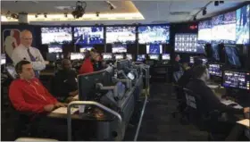  ?? BRIAN MAHONEY — THE ASSOCIATED PRESS ?? Joe Borgia, standing left, NBA senior vice president of replay and referee operations, talks to senior replay manager Monte Shubik at the National Basketball Associatio­n Replay Center in Secacus N.J., Thursday. They are in the games, just not at the...