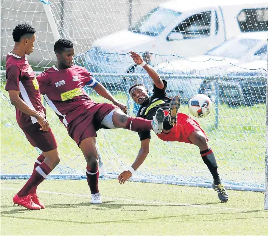  ?? Picture: MICHAEL PINYANA ?? HI-JINKS: EC Bees’s Athini Bisha and Sonwabo Maqokolo make a valiant effort to stop Aluncedo Mazwi, right, from scoring for Tornado at North End at the weekend