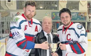 ??  ?? Scottish Ice Hockey’s Alex Cram presents the SNL league trophy to Comets assistant captain Kris Phillips (left) and captain Lewis Gold.