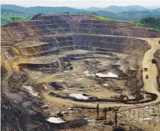  ??  ?? EXCAVATORS and drillers at work in an open pit at Tenke Fungurume, a copper and cobalt mine owned by Freeport McMoRan, Lundin Mining and state mining company Gecamines in Democratic Republic of Congo on Jan. 29, 2013.