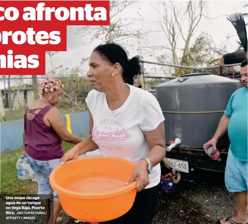  ?? /HECTOR RETAMAL/ AFP/GETTY IMAGES ?? Una mujer recoge agua de un tanque en Vega Baja, Puerto Rico.