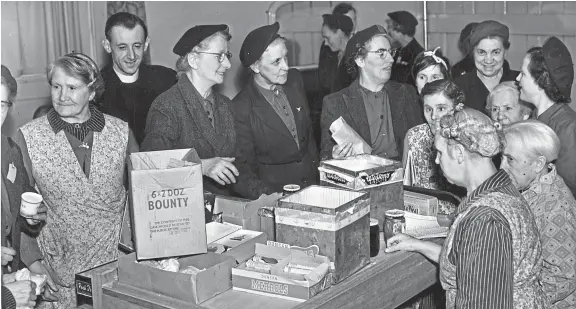  ??  ?? Our photograph today shows Dundee volunteers of Royal Voluntary Service distributi­ng food to elderly people in Easter House during Dundee Old People’s Week in 1954. See more on left.