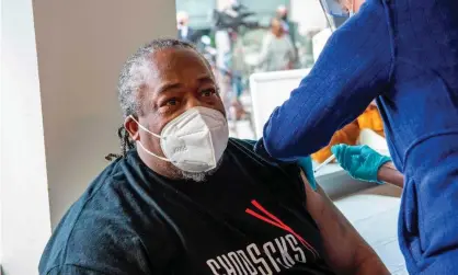  ?? Photograph: Joseph Prezioso/AFP/Getty Images ?? Frank Tate, a staff member and former client of The Open Hearth mens shelter, receives a Covid vaccine in Hartford, Connecticu­t on22 January 2021.