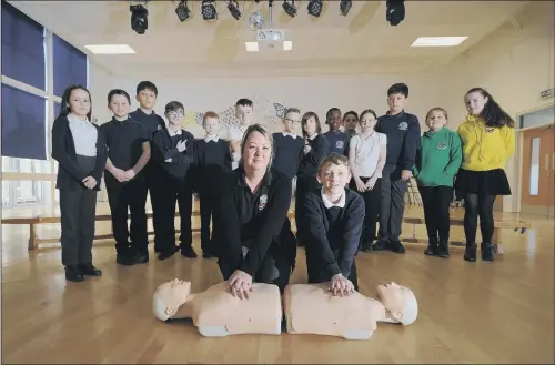  ?? PICTURES: SIMON HULME. ?? LIFESAVERS: Julie Haines shows Kyle Marsh CPR as pupils learn first aid at Worsboroug­h Bank End Primary School, Barnsley .