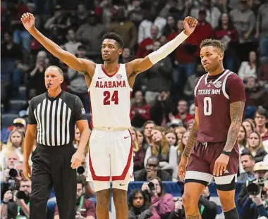  ?? Photos by John Amis/Associated Press ?? Alabama forward Brandon Miller, who had a game-high 23 points, celebrates as Texas A&M guard Dexter Dennis looks on in the final minutes of the Southeaste­rn Conference tournament final on Sunday.