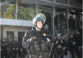  ??  ?? CHP Officer Markell and fellow police officers maintain a perimeter in preparatio­n for Shapiro’s talk. Security for the event cost UC Berkeley an estimated $600,000.