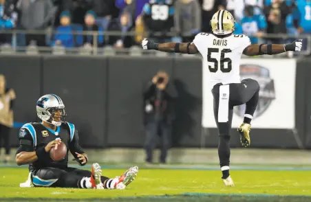  ?? Jason E. Miczek / Associated Press ?? New Orleans linebacker Demario Davis celebrates his first-half sack of the Panthers’ Cam Newton, one of four by the Saints.