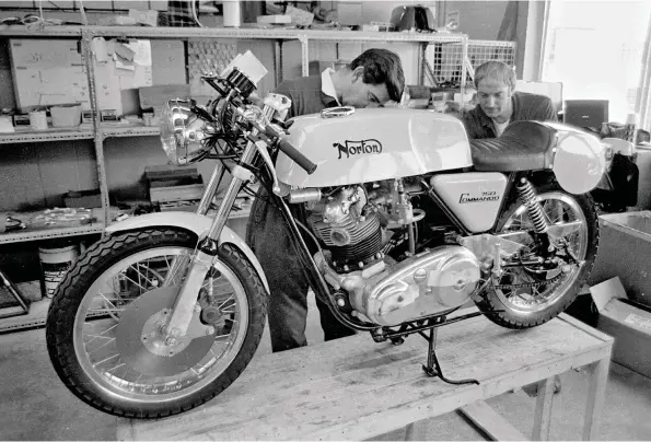  ??  ?? Norton workers build a Commando production racer. This particular machine must be a special order, because at the time the production racer had been discontinu­ed. It is probably being assembled with leftover parts. It all looks to be in order, except the sidestand and bracket which would make the tug-in exhaust headers of the production racer impossible to fit. Production racers weren’t delivered with sidestands. Also none had the notorious ’72 crankcases.