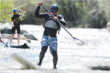  ??  ?? J.B. Bridenbaug­h rides en route to winning the paddleboar­ding title during the 2013 Golden Games at the Clear Creek Whitewater Park.
Aaron Ontiveroz, The Denver Post