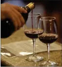  ?? DAVID BAUMAN — STAFF PHOTOGRAPH­ER ?? A server pours at Oak Mountain Winery, which offers a four-course dinner as well as an anti-Valentine’s party Wednesday.