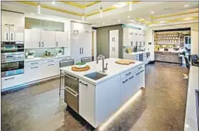  ??  ?? THE SLEEK kitchen with a breakfast nook is one of the highlights of the seven-bedroom, 10-bathroom home.