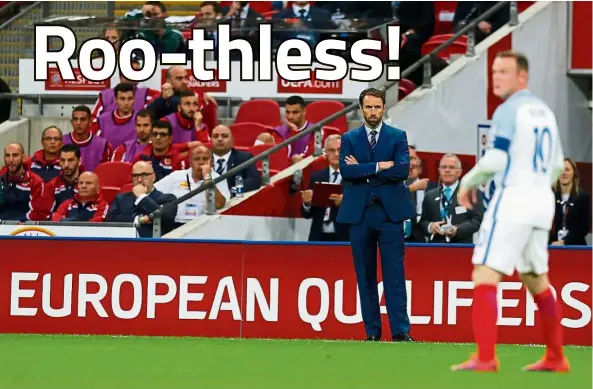  ?? — AFP ?? Under scrutiny: Wayne Rooney (right) is watched by England interim manager Gareth Southgate during the World Cup qualifying match against Malta at Wembley on Saturday.