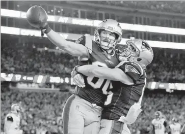  ?? David J. Phillip Associated Press ?? DANNY AMENDOLA, left, celebrates a touchdown catch with fellow receiver Chris Hogan in New England’s win over Jacksonvil­le in the AFC championsh­ip game, which put the Patriots in the Super Bowl again.