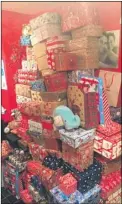  ?? ?? Emma Reed with her children Ronnie and Ellie; this mountain of presents was donated last Christmas – this year Emma is asking people to donate shopping vouchers