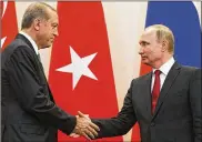  ?? ALEXANDER ZEMLIANICH­ENKO / ASSOCIATED PRESS ?? Russian President Vladimir Putin (right) and Turkish President Recep Tayyip Erdogan shake hands after a news conference following their talks in Putin’s residence in the Russian Black Sea resort of Sochi on Wednesday.