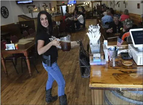  ?? RJ SANGOSTI - THE DENVER POST ?? Lauren Boebert, owner of Shooters Grill, has gained national attention for her decision to encourage her staff to carry a firearm during work. The restaurant was photograph­ed on 2018in Rifle.