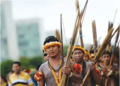  ?? — AFP ?? BRASILIA: Indigenous people march at the Esplanade of the Ministries in Brasilia during a nationwide strike called by unions opposing austerity reforms.