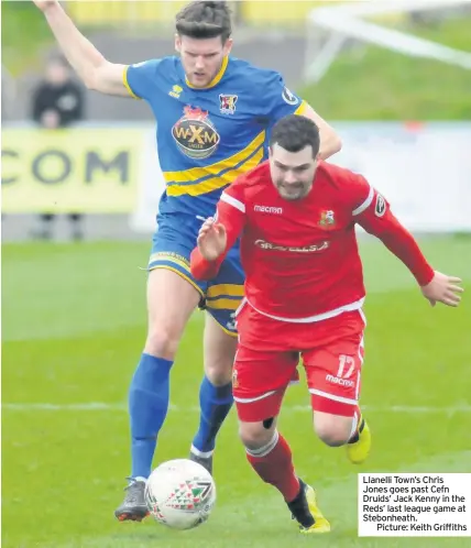  ??  ?? Llanelli Town’s Chris Jones goes past Cefn Druids’ Jack Kenny in the Reds’ last league game at Stebonheat­h.
Picture: Keith Griffiths