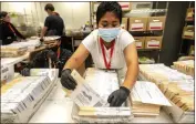  ?? WATCHARA PHOMICINDA — THE ORANGE COUNTY REGISTER VIA AP ?? An election worker processes mail-in-ballots for the midterm election in Riverside on Nov. 10.