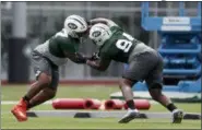  ?? JULI CORTEZ — THE ASSOCIATED PRESS ?? The New York Jets’ Nathan Shepherd, left, who was drafted in the third round of the 2018 draft, works out with Folorunso Fatukasi, who was drafted in the sixth round, during NFL rookie camp, Saturday in Florham Park, N.J.