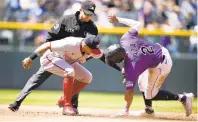  ?? DAVID ZALUBOWSKI/AP ?? Washington second baseman Cesar Hernandez, left, tags out Colorado’s Yonathan Daza as he tries to steal second on Thursday in Denver.