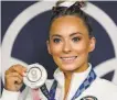  ?? Ashley Landis / Associated Press ?? U.S. gymnast MyKayla Skinner shows off her silver medal after the vault finals.