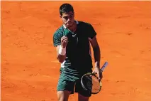  ?? BERNAT ARMANGUE/ASSOCIATED PRESS ?? Spain’s Carlos Alcaraz reacts during his match against fellow Spaniard Rafael Nadal on Friday at the Madrid Open.