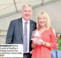  ??  ?? DelightedM­arion Curley of Healthy n’ Happy receives her award from James Kelly MSP