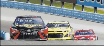  ?? Julie Jacobson The Associated Press ?? Martin Truex Jr., front, leads Landon Cassill, center, and Ricky Stenhouse Jr. around Watkins Glen Internatio­nal Speedway during Saturday practice.