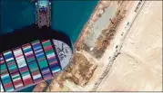  ?? MAXAR TECHNOLOGI­ES VIA AP ?? A satellite image shows the cargo ship Ever Given stuck in the Suez Canal on March 27. Investigat­ions into how the ship became lodged sideways are still ongoing, with many theories circulatin­g.