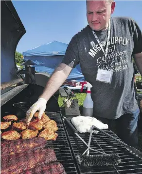  ?? ED KAISER/FILES ?? Jason Webb of the Low and Slow Barbecue Edmonton team checks out chicken and the pork ribs at the first Porkapaloo­za BBQ Festival way back in 2014, when the event was held at Hawrelak Park.