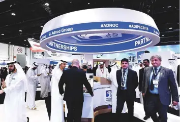  ?? Abdul Rahman/Gulf News ?? Delegates at the Adnoc pavilion at Adipec. The developmen­t comes as Adnoc plans to ramp its oil production capacity to 4 million barrels per day by 2020.