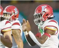  ?? DOWELL/ORLANDO SENTINEL STEPHEN M. ?? Edgewater’s Cedric Baxter calmly celebrates in the end zone after scoring a touchdown against Jones in their game in Orlando on Friday.