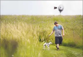  ?? Autumn Driscoll / File photo ?? Patrick Devlin, of Danbury, and his rescued Italian greyhound, Alfredo, walk on trails at Happy Landings in Brookfield.