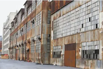  ?? Photos by Paul Chinn / The Chronicle ?? Panes of glass are missing from historic Building 12 at Pier 70. The building would become a “makers’ hall” under the plan, which would also create arts spaces and waterfront access.