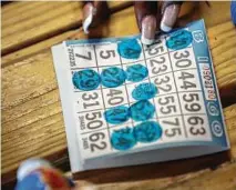  ??  ?? Bingo players mark up their cards during a game of “blackout” at Eureka Heights.