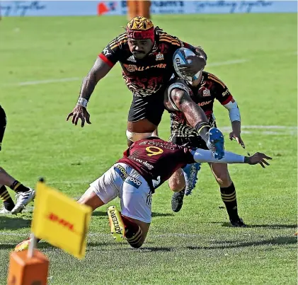  ?? GETTY IMAGES. ?? Chiefs No8 Pita Gus Sowakula hurdles Aaron Smith to score a try during the opening round of the Super Rugby Pacific match against the Highlander­s.