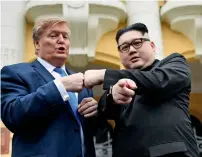  ?? AFP ?? US President Donald Trump impersonat­or Russel White and North Korean leader Kim Jong-un impersonat­or Howard X) pose together for photograph­s outside the Opera House in Hanoi, Vietnam, on Saturday. —