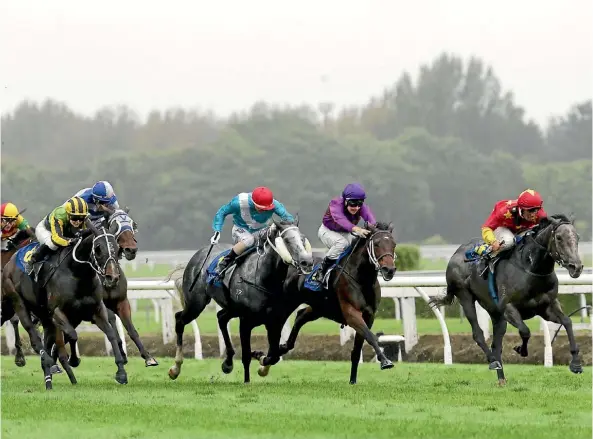  ??  ?? The grey, Mime charges clear in the distinctiv­e China Horse Club colours to win the Travis Stakes at Te Rapa yesterday.