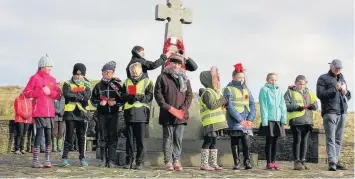  ??  ?? ● Pupils from Northern Primary School in Weir walked to Deerplay War Memorial on the hill above Bacup to remember the fallen