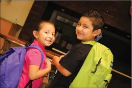  ?? Courtesy photo ?? Two young, happy recipients of brand new backpacks filled with school supplies courtesy of Single Mothers Outreach.