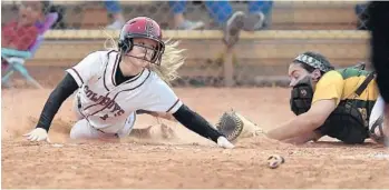  ?? MICHAEL LAUGHLIN/STAFF PHOTOGRAPH­ER ?? Cooper City’s Jasmin Herrera evades the tag from Nova catcher Holly Walsh during their 8A Regional Semifinal softball game on Tuesday.