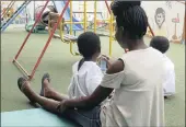  ??  ?? EDUCATION: A mom entertains her children in the special children’s play area at the hospital.